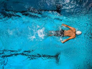 Person Swimming on Body of Water